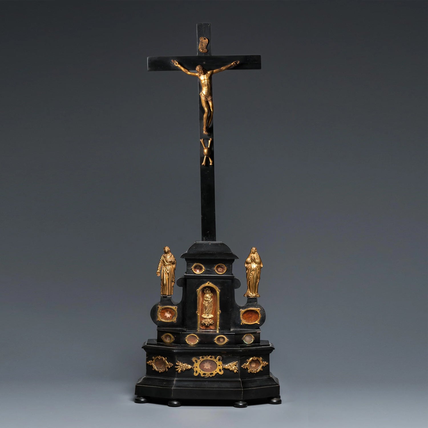 AN EBONY WOOD AND GILT BRONZE RELIQUARY ALTAR CROSS AFTER GIAMBOLOGNA