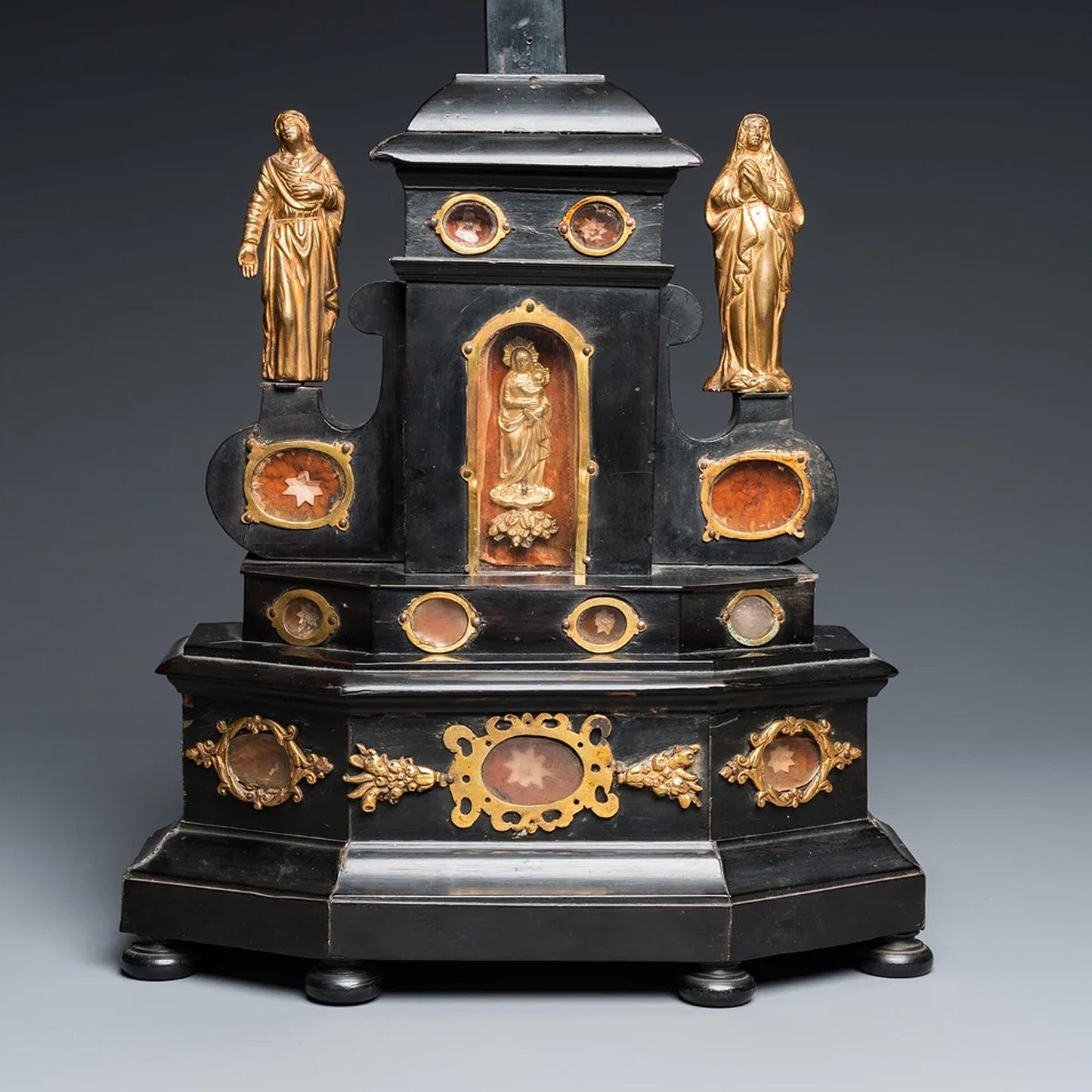 AN EBONY WOOD AND GILT BRONZE RELIQUARY ALTAR CROSS AFTER GIAMBOLOGNA