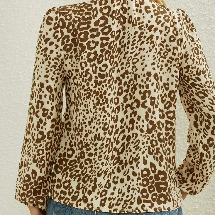 Long-sleeved light medium brown leopard print ruffled collar blouse with lantern sleeve cuffs.